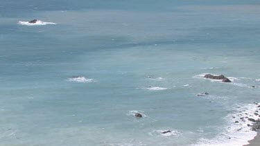 Gentle waves on pristine cove and shoreline