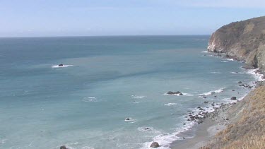 Gentle waves on pristine cove and shoreline