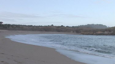 Gentle waves on pristine cove and shoreline