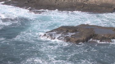 Waves crashing on rocky shore