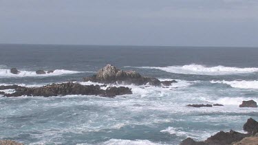 Waves crashing on rocky shore