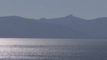 Sparkling lake in alpine setting with distant shoreline