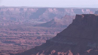 Rocky Canyon; sheer and deep; monumental buttes, boulders, Indian caves, and mesas