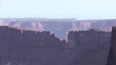 Rocky Canyon; sheer and deep; monumental buttes, boulders, Indian caves, and mesas