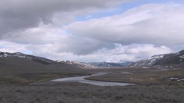 A broad river valley in the Rocky Mountains