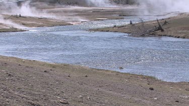 A sparkling river flows in smoke and fire