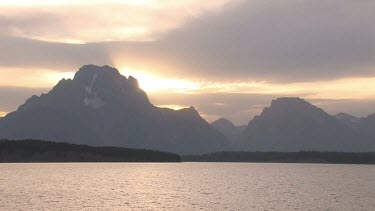 Sunset over the Teton wilderness mountains and lake