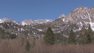 Broad rocky canyon; sheer and deep; monumental buttes, boulders, and mesas