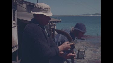 worker cleaning equipment at whaling station