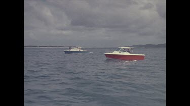 two boats sailing. gloomy skies