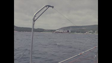 dead whale being moved by boat