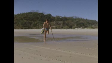 Henri Bource hopping along beach with Valerie