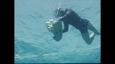 Henri swimming with camera in hand