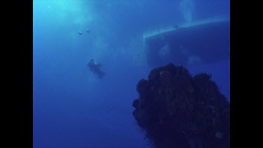 two divers swim around Yolanga wreck