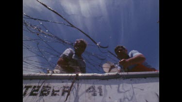 Government contractors hauling the nets out of the sea to clear them