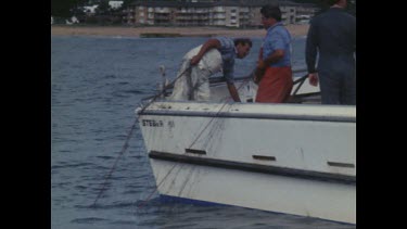 Government contractors hauling the nets out of the sea to clear them