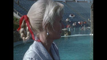 Valerie Taylor looks at orcas contained in small pool at San Diego Seaworld in the 1970s