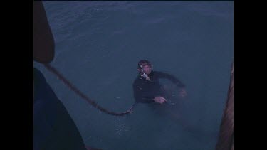 diver in water by ship wreck