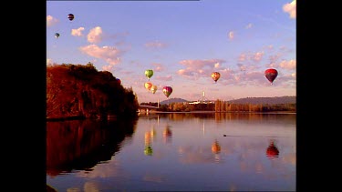 hot air balloons with parliament in background