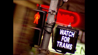 Trams passing in front of Tram sign