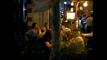 busy city pavements sidewalks at night filled with sidewalks cafs. St Kilda Melbourne.