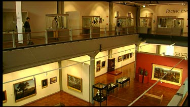 High Angle. Tourists looking at art display at Queen Victoria Museum