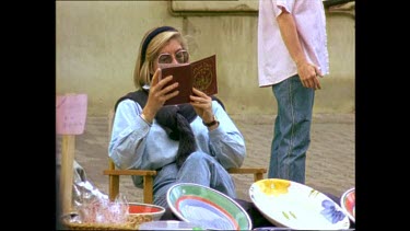 Woman selling ceramics at flea market