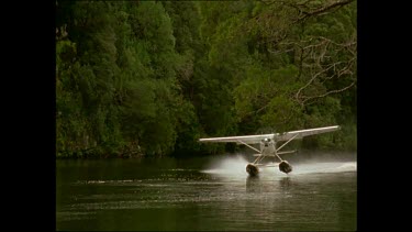 Seaplane taking off along river. Franklin River