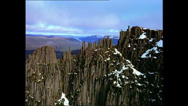 Jagged peak of eroded mountain peak, snow covered mountain.