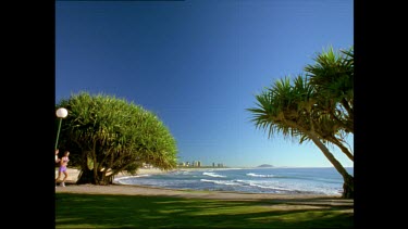 WS. Joggers running along beach promenade