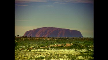 Uluru with bush scrub in FG