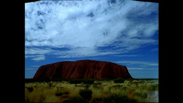 Uluru with bush scrub in FG