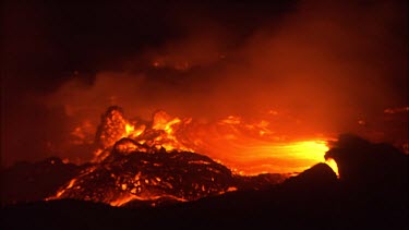 Active Volcano. Steam smoke and slow moving lava. Debris.