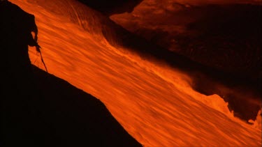 Zoom out from cu lava flow to WS showing side of volcano with solidifed lava and lava flow steam.