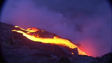 Lava flow and steam and recently solidified lava. The steam is from the ocean. The lava is heating boiling the sea water.