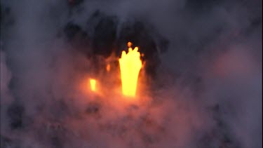 CU steam at edge of lava delta and incandescent lava flow. It looks like flames but its not - its the molten rock of the lava flow.