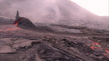 Active lava field. Molten lava travels beneath the solidified lava crust in lava tubes. At times it erupts to the surface through vents and holes in the crust.