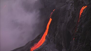 Along lava flow. Recently solidified lava crust. Very steamy and smokey.