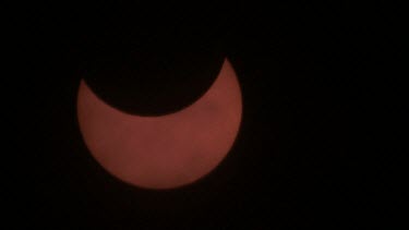 partial solar eclipse with clouds in foreground, Israel 2011