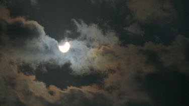 Beginning of solar eclipse against grey sky, Israel 2011