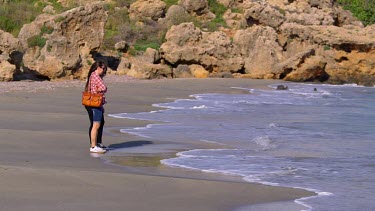 Tourists Walk On Beach & Dodge Waves, Frangokastello, Crete, Greece