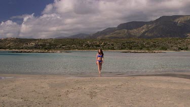 Teenage Girl Walks Out Of Sea, Elafonisi, Crete, Greece