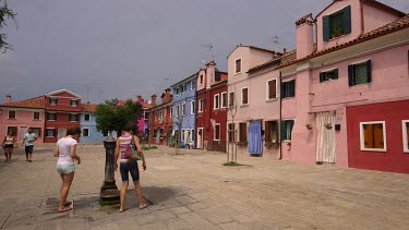 Women Wash Hands In Fountain, Burano, Venice, Italy