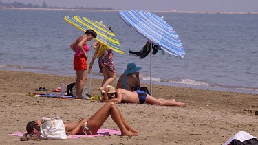 Sunbathing On Beach With Parasols, Lido, Venice, Italy