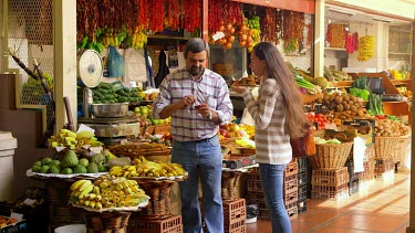 Customer Tries Spices, Funchal Market, Madeira, Portugal