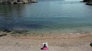 Attractive Woman Sunbathing On Beach, Balaklava, Criema, Ukraine