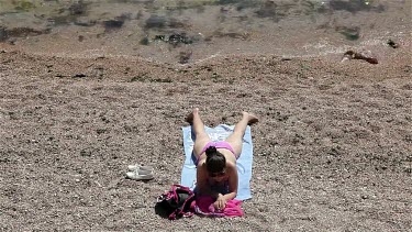 Attractive Woman Sunbathing On Beach, Balaklava, Criema, Ukraine