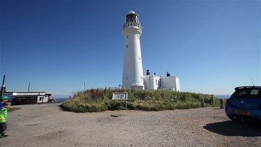 Children Look At Lighthouse Sign, Flamborough Head, East Yorkshire, England