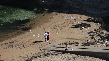 People Walking Dog On Beach, Thornwick Bay, East Yorkshire, England