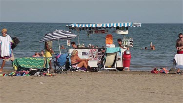 Man Moving Drinks Trolly On Beach, Lido, Venice, Italy